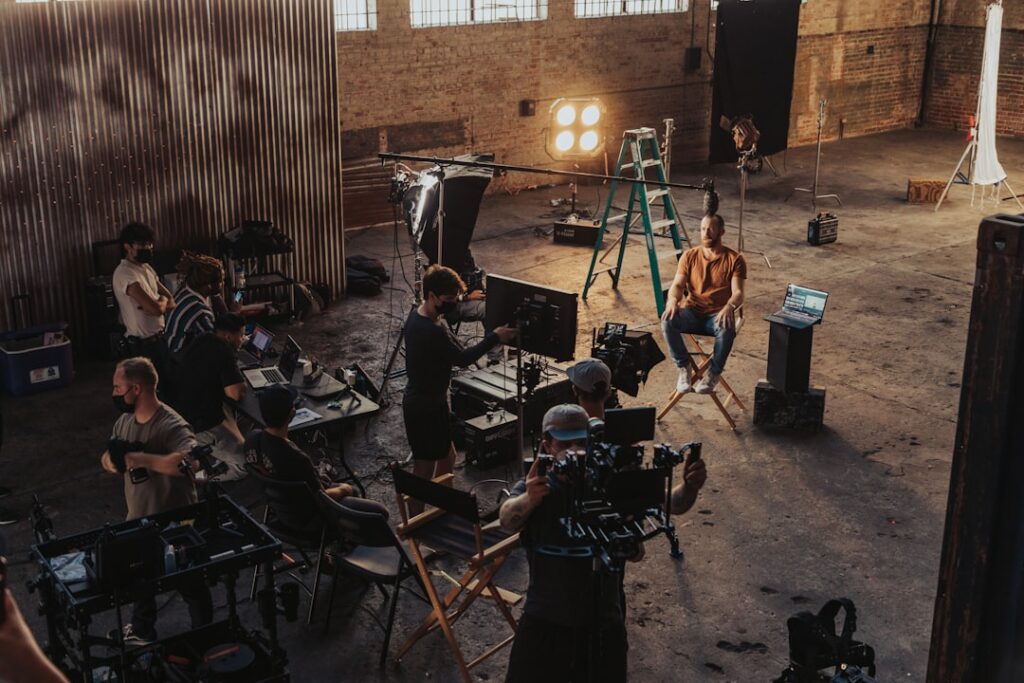 Film crew gathered around a camera setup between takes