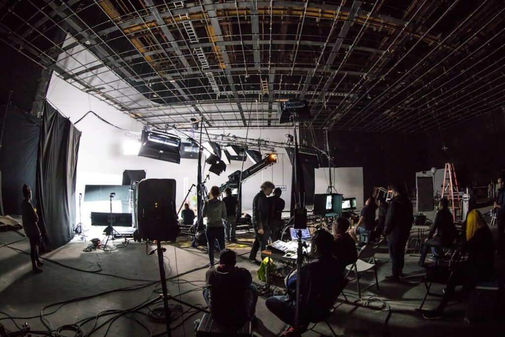 Wide-angle view of a film set with lighting rigs and camera equipment