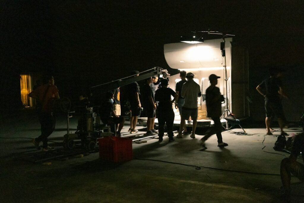 Film crew setting up equipment for a night shoot